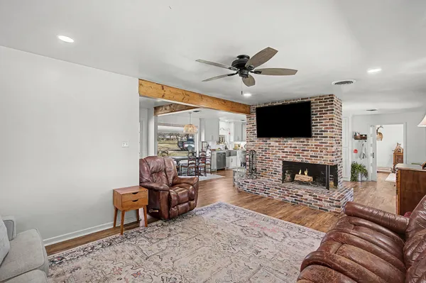 a living room with furniture a fireplace and a flat screen tv
