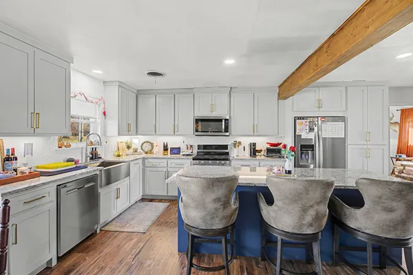 a kitchen with granite countertop lots of counter top space and appliances