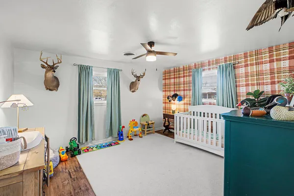a bedroom with furniture and chandelier