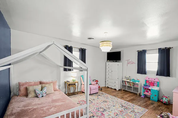 a bedroom with furniture and a chandelier