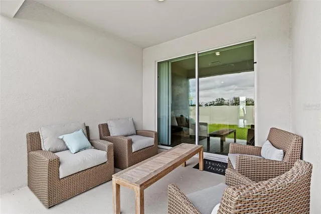 a living room with furniture and a floor to ceiling window