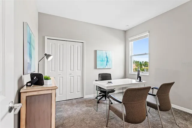 a view of a dining room with furniture and window