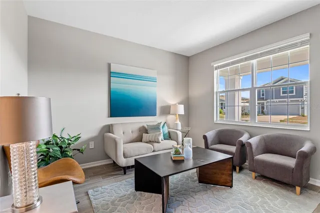 a living room with furniture and a potted plant