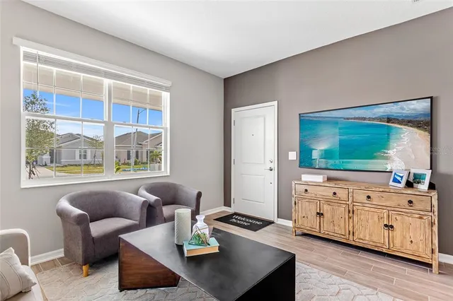 a living room with furniture and flat screen tv