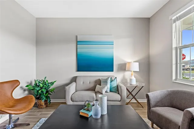 a living room with furniture and a potted plant
