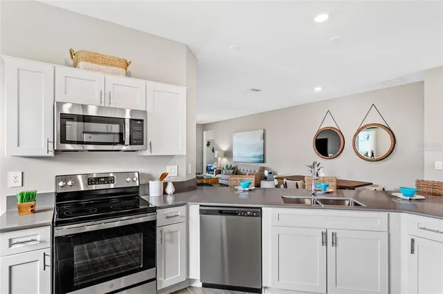 a kitchen with stainless steel appliances granite countertop a stove and a microwave