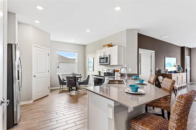 a view of a dining room with furniture and wooden floor