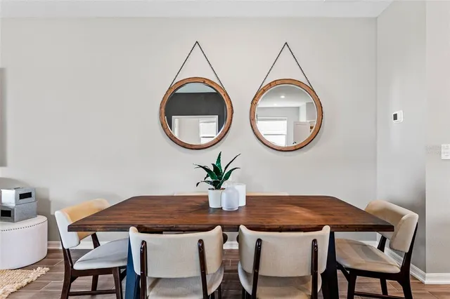 a dining room with furniture and a potted plant