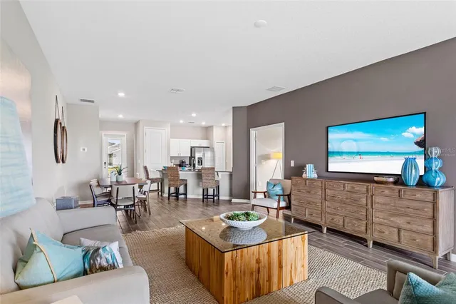 a living room with furniture and wooden floor