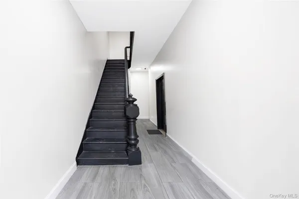 a view of entryway and hall with wooden floor