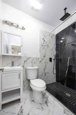 a bathroom with a sink toilet and shower