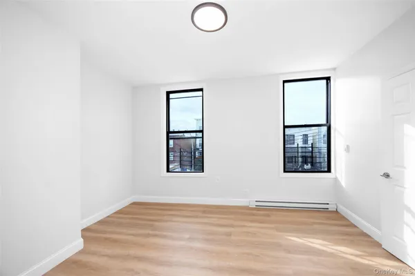 an empty room with windows and closet