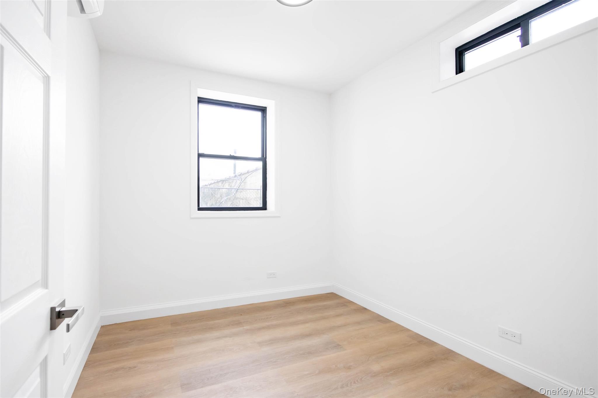 2064 Bathgate Avenue Bronx, NY 10457 - Photo 5 of 14 an empty room with a window