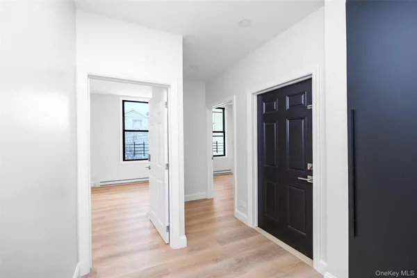 a view of a hallway with wooden floor