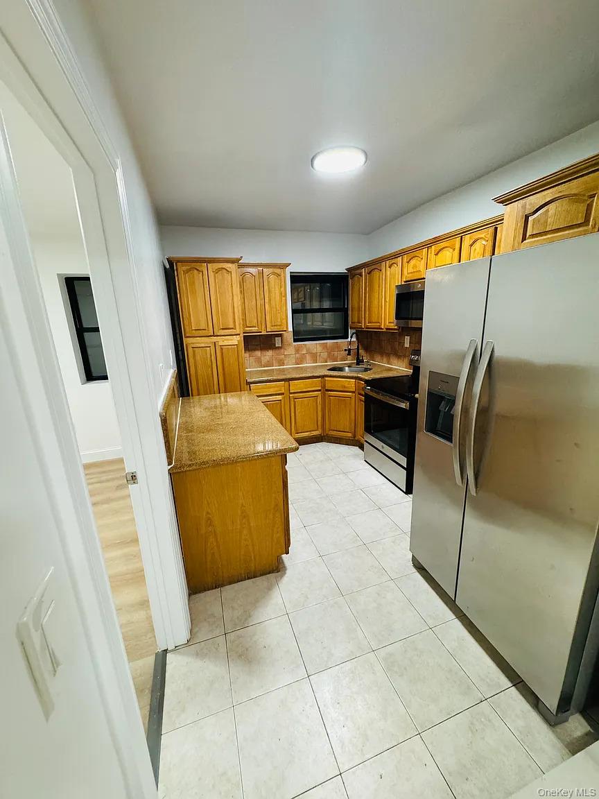 2064 Bathgate Avenue Bronx, NY 10457 - Photo 8 of 14 a living room with furniture and a flat screen tv