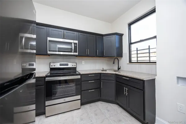 a kitchen with a sink stove and microwave