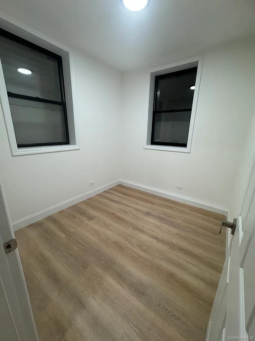 2064 Bathgate Avenue Bronx, NY 10457 - Photo 9 of 14 a view of a livingroom with wooden floor and cabinet