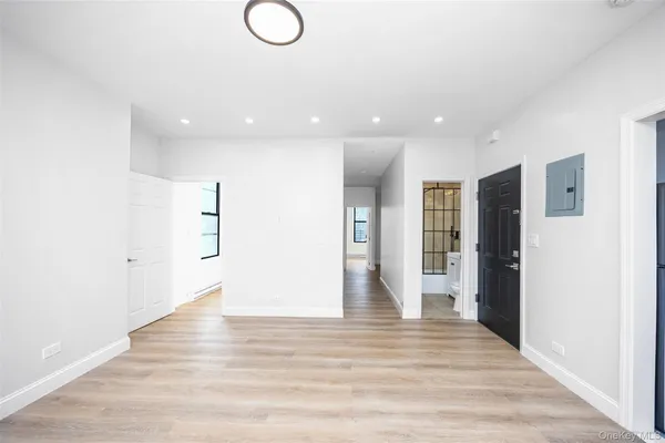 a view of a hallway with wooden floor