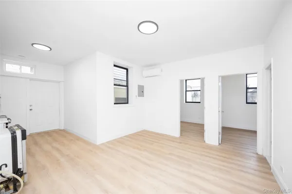 a view of a room with wooden floor and window