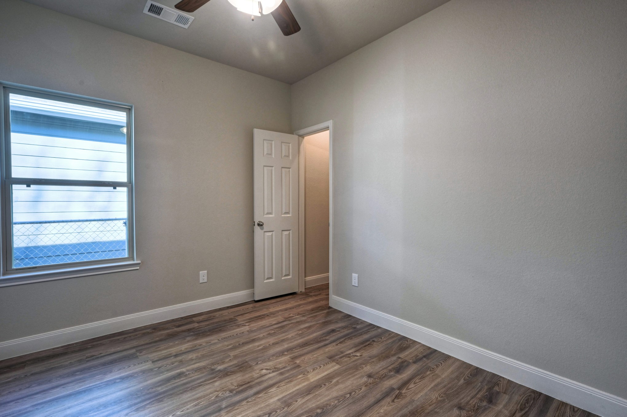 9173 Inwood Willis, TX 77318 - Photo 17 of 31 an empty room with wooden floor cabinet and windows