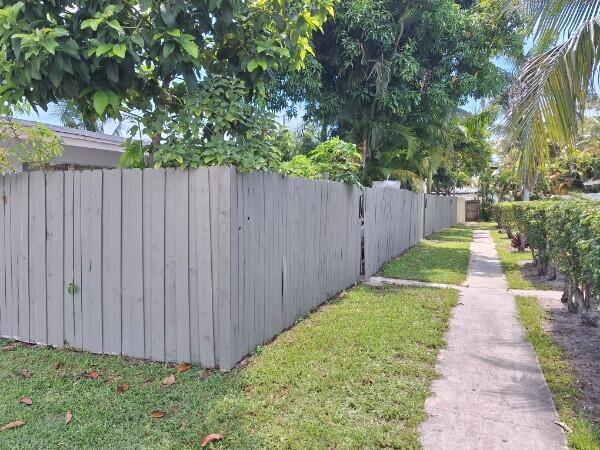 3386 Rudolph Road Lake Worth Beach, FL 33461 - Photo 3 of 25 a view of a pathway of a garden with wooden fence