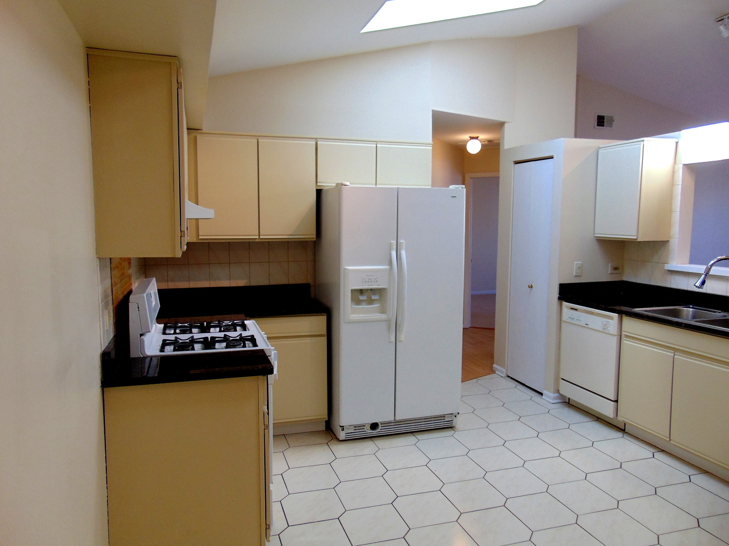 1662 Commodore Court, Unit 2 Schaumburg, IL 60193 - Photo 2 of 26 a kitchen with stainless steel appliances a refrigerator sink and stove