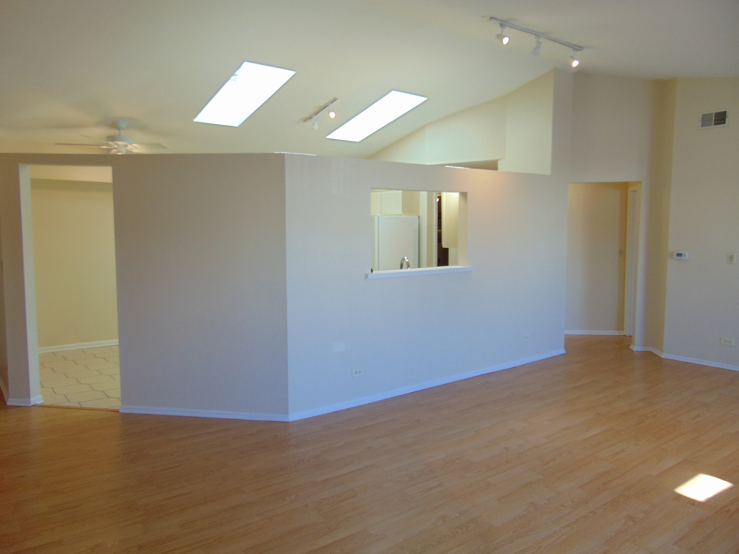 1662 Commodore Court, Unit 2 Schaumburg, IL 60193 - Photo 9 of 26 a view of an empty room with wooden floor and a window