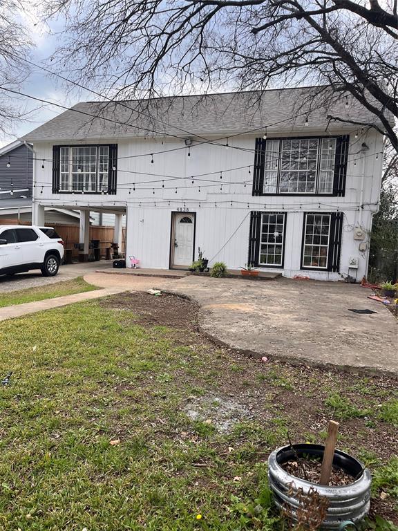 a view of a house with backyard porch and sitting area