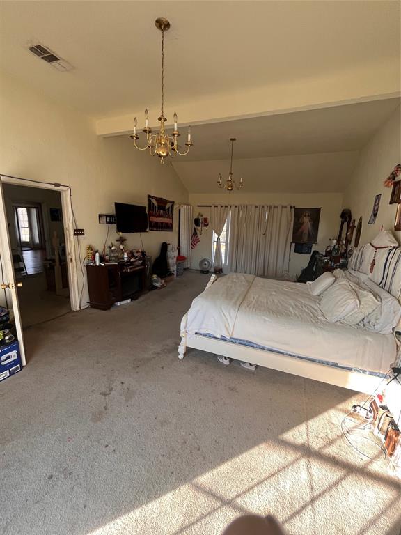 4838 Wisteria Street Dallas, TX 75211 - Photo 11 of 19 a living room with furniture a chandelier and a flat screen tv