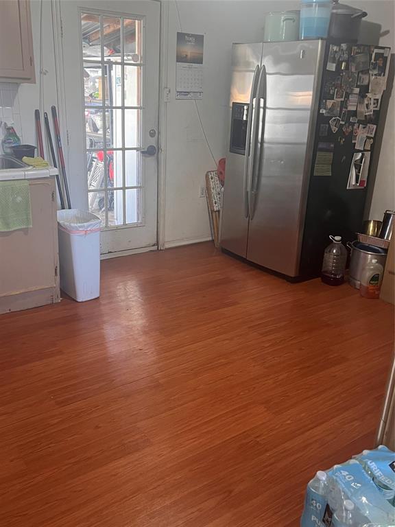 4838 Wisteria Street Dallas, TX 75211 - Photo 13 of 19 a view of a refrigerator in kitchen and livingroom