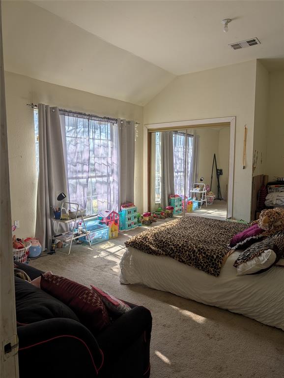 4838 Wisteria Street Dallas, TX 75211 - Photo 19 of 19 a bedroom with a bed and large windows