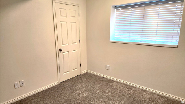 778 North 250 West Springville, UT 84663 - Photo 14 of 16 Unfurnished bedroom featuring baseboards and dark colored carpet