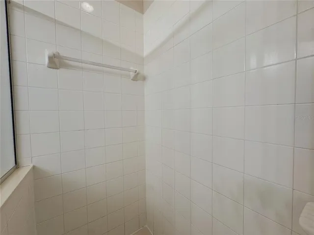 a bathroom with a glass shower door