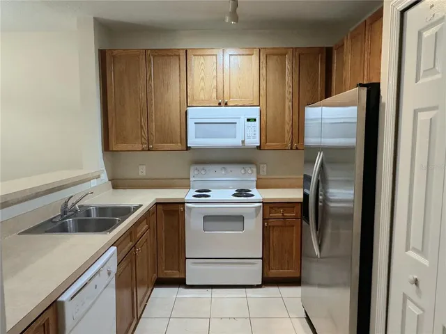 a kitchen with a stove sink and cabinets