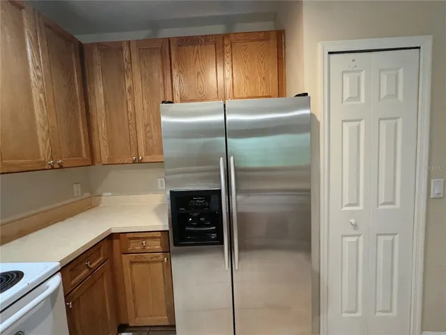 a kitchen with a refrigerator and cabinets