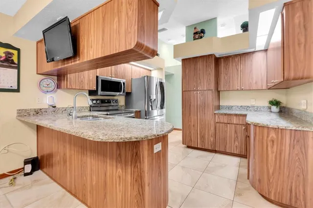 a kitchen with stainless steel appliances granite countertop a stove microwave and cabinets