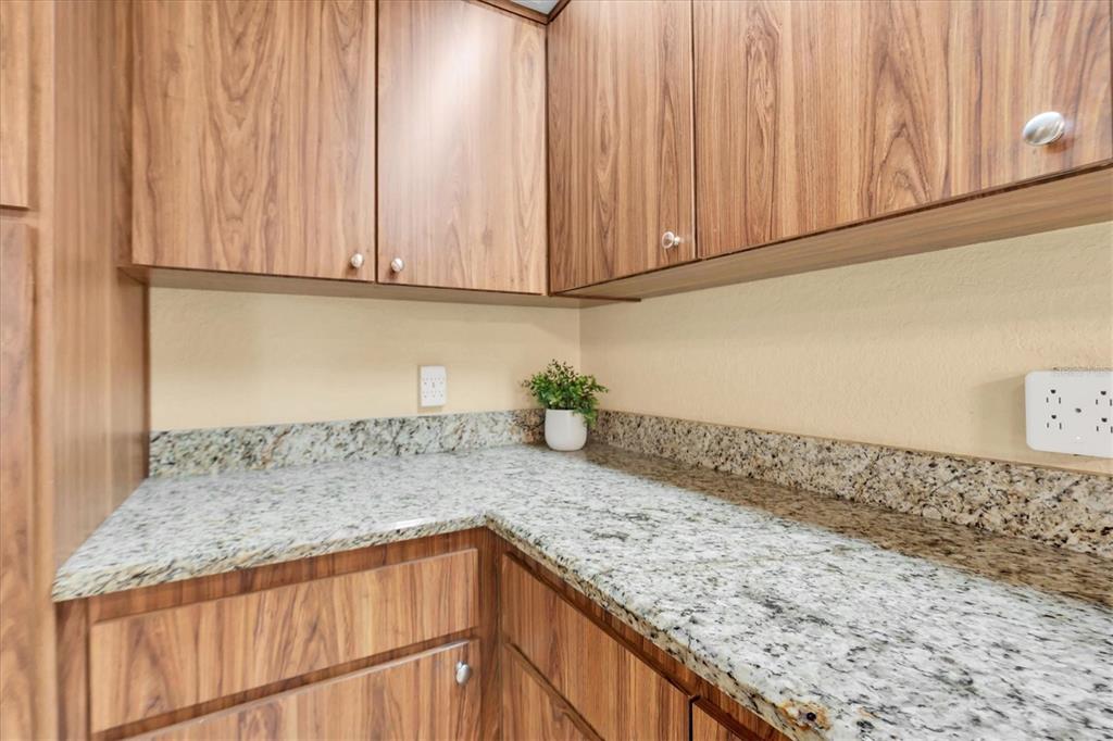 18809 Parade Road Hudson, FL 34667 - Photo 13 of 37 a kitchen with granite countertop stainless steel appliances granite countertop a sink and cabinets