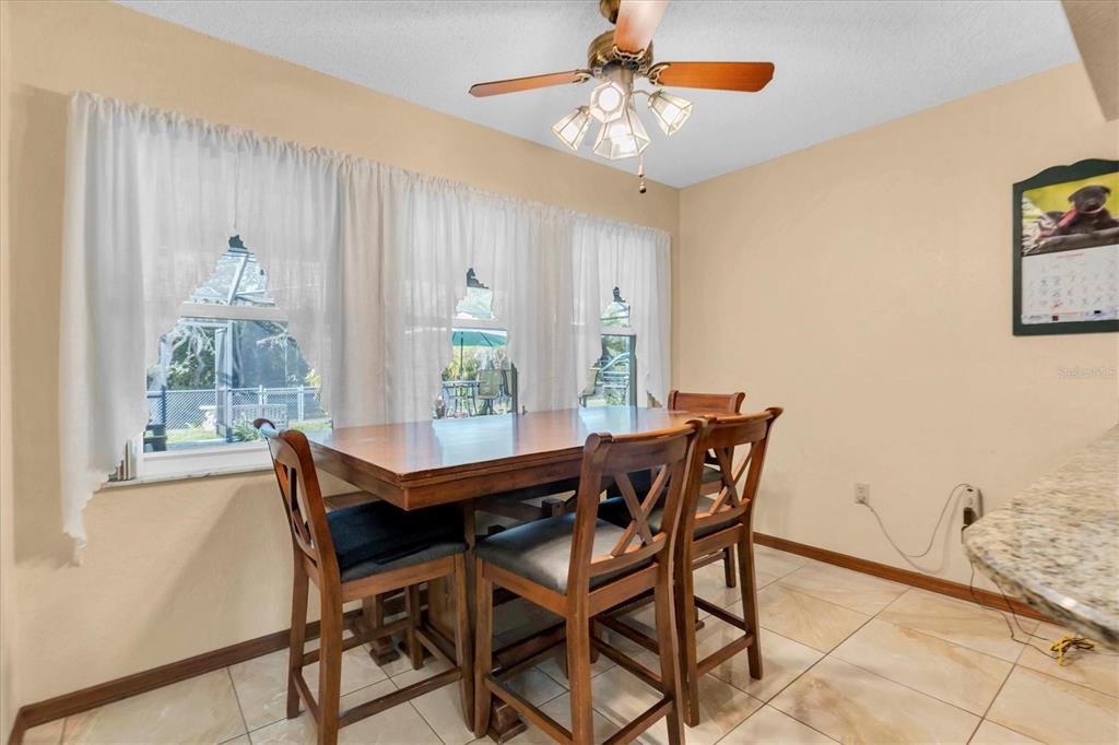18809 Parade Road Hudson, FL 34667 - Photo 15 of 37 a view of a dining room with furniture and chandelier