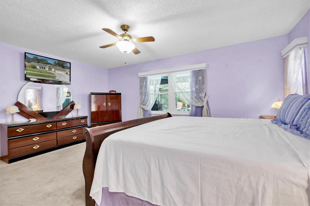 18809 Parade Road Hudson, FL 34667 - Photo 18 of 37 a bedroom with a bed and wooden floor