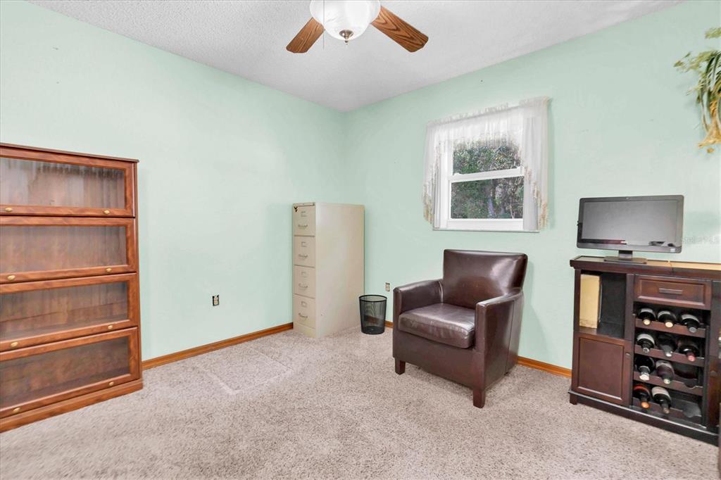 18809 Parade Road Hudson, FL 34667 - Photo 21 of 37 a living room with furniture and a window