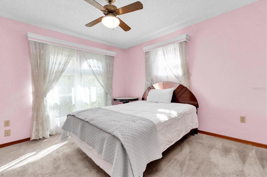 18809 Parade Road Hudson, FL 34667 - Photo 22 of 37 a bedroom with a bed and window