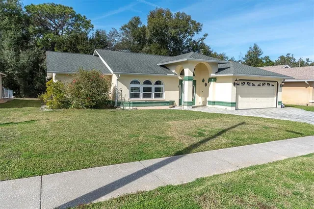 a front view of a house with a yard and garage