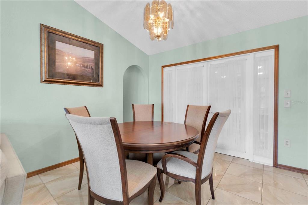 18809 Parade Road Hudson, FL 34667 - Photo 10 of 37 a view of a dining room with furniture and chandelier
