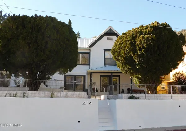 a front view of a house with a garden