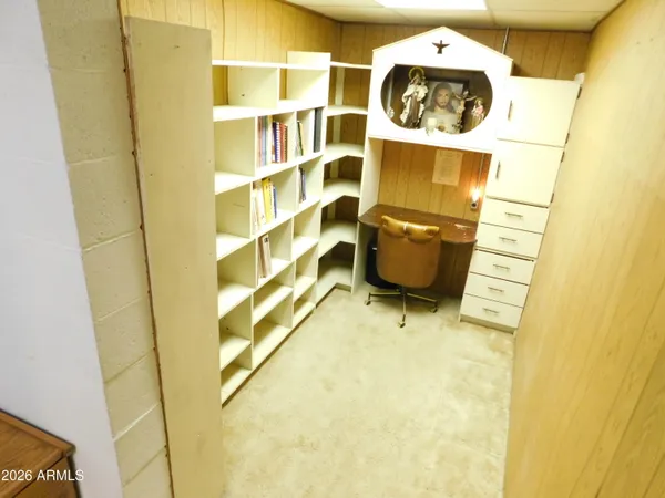 a room with a fireplace and cabinets