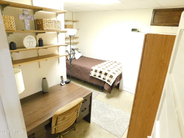 a bedroom with bed and a window