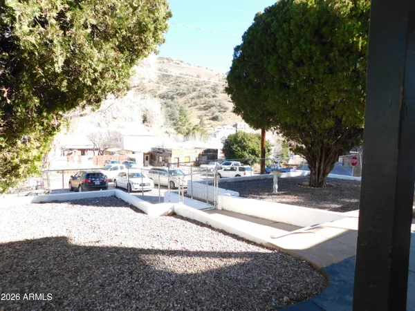 a view of a house with backyard and sitting area