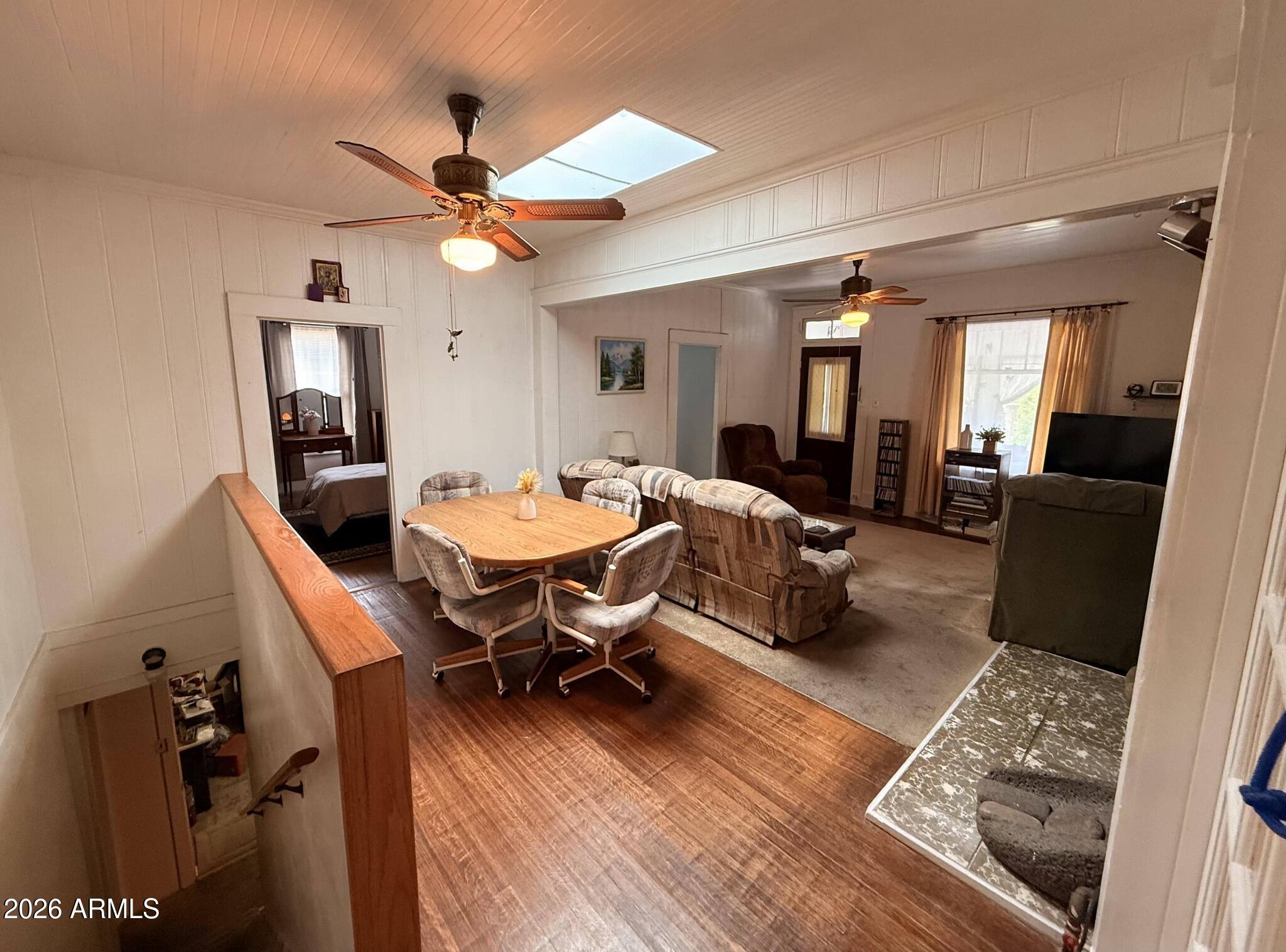 414 Tombstone Canyon Bisbee, AZ 85603 - Photo 4 of 44 a living room with furniture a rug and a chandelier