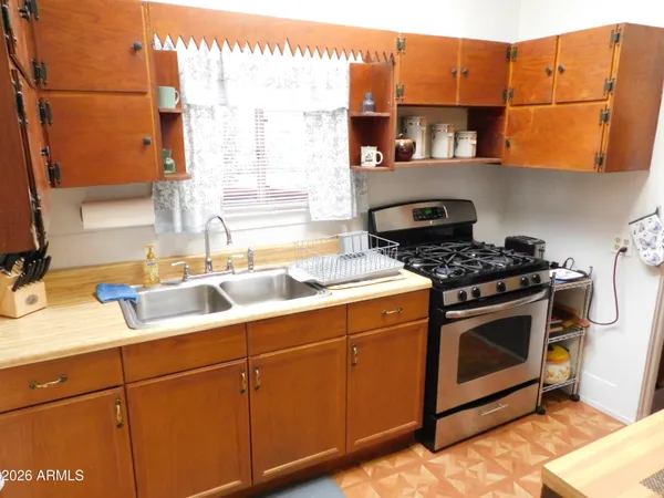 a kitchen with stainless steel appliances granite countertop a sink a stove and a microwave