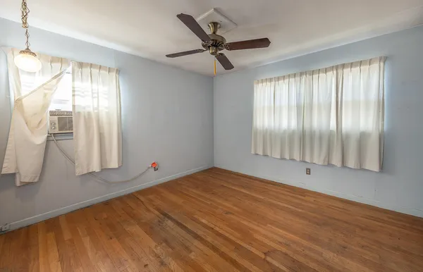 a view of an empty room and wooden floor